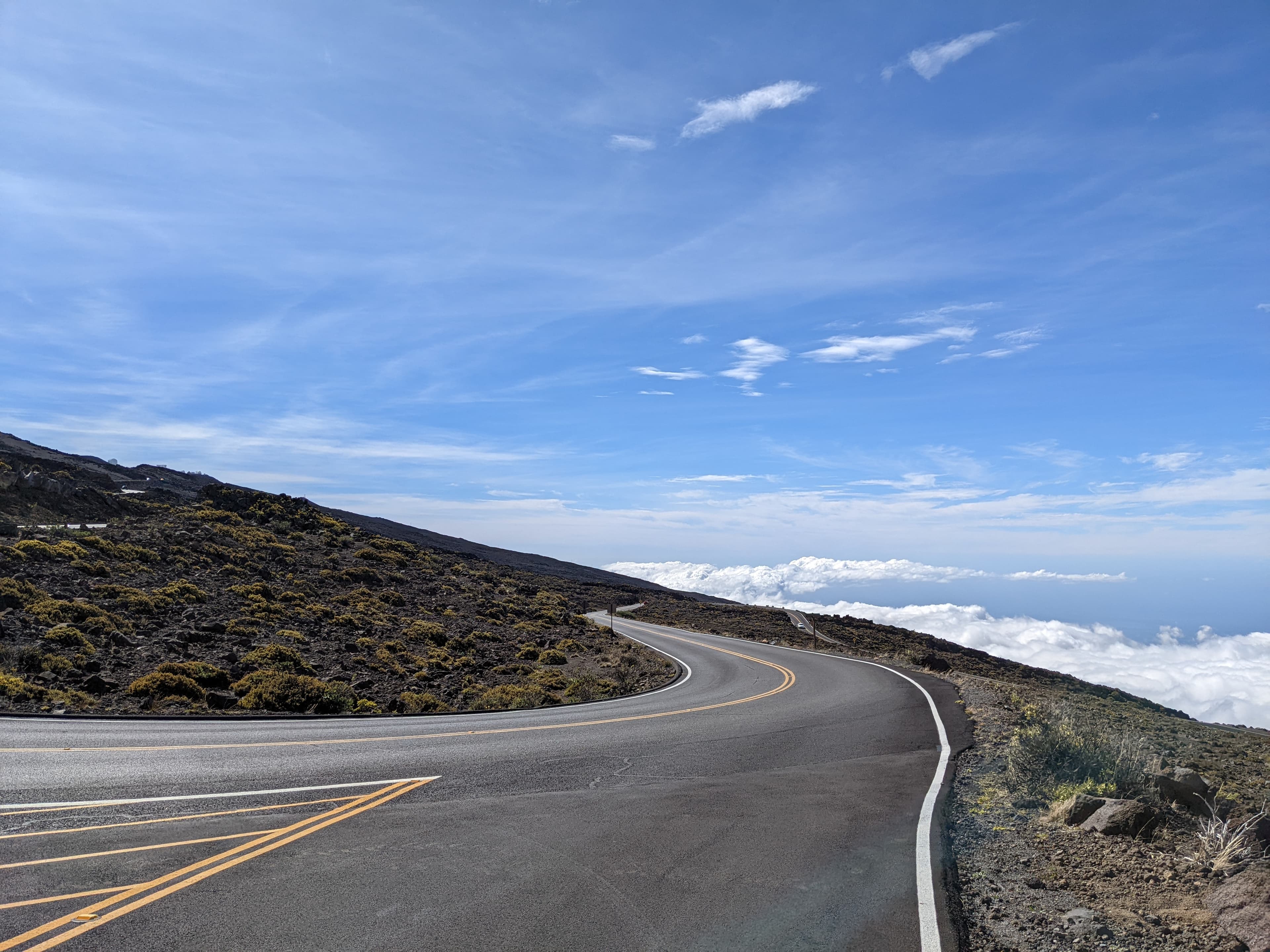 Paved switchback road above the clouds